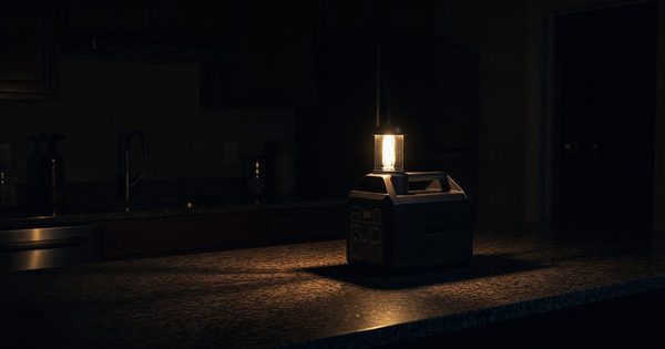Portable power station and lantern illuminating a dark kitchen counter during an outage